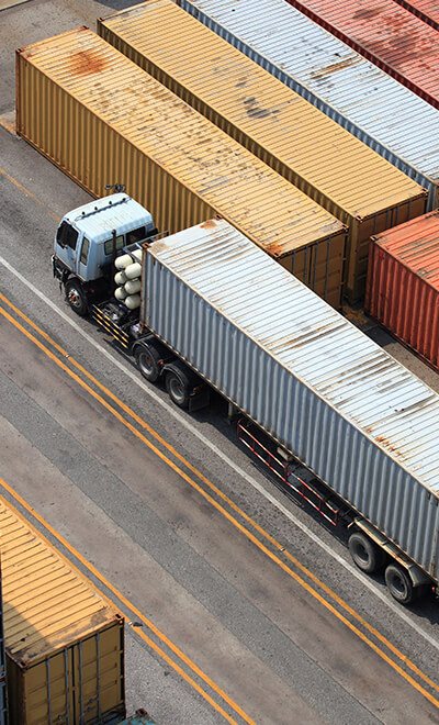 Truck with a container moving through a port terminal