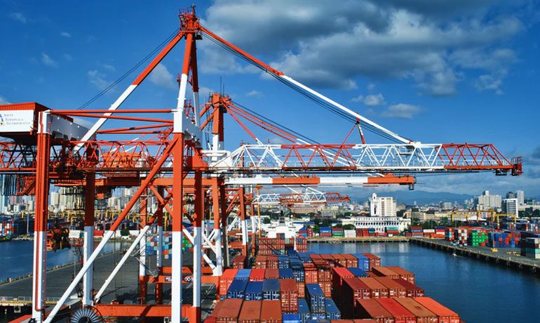 Gantry cranes operating over containers at a marine terminal